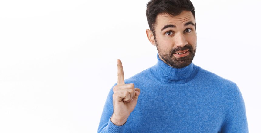 portrait-handsome-smart-bearded-man-add-solution-have-idea-suggestion-raising-one-finger-tell-recommendation-give-advice-as-standing-white-wall(FILEminimizer)